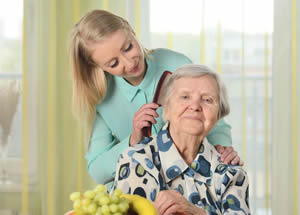 Elderly woman receiving personal care; Medicaid and Elder Law in Kansas and Missouri
