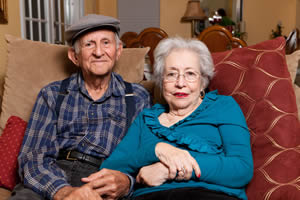 Elderly couple sitting together; Signs of Financial Abuse of the Elderly